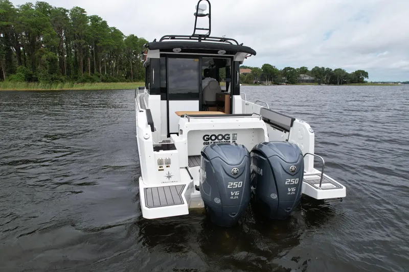  Yacht Photos Pics 2023 Jeanneau NC Sport 895 boat with dual 250 V6 engines on a lake.