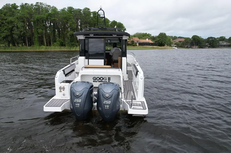  Yacht Photos Pics 2023 Jeanneau NC Sport 895 boat with dual 250 V6 engines on a lake.