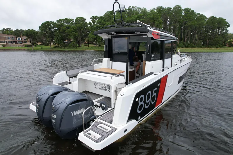  Yacht Photos Pics 2023 Jeanneau NC Sport 895 boat with twin Yamaha engines on a calm lake.