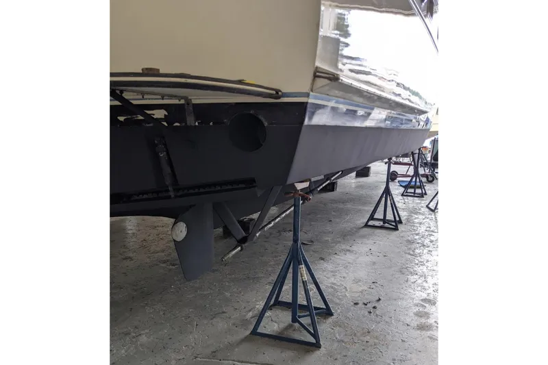 Sky To Sea Yacht Photos Pics 1984 Hatteras 53 Extended Deckhouse Motor Yacht on stands in a maintenance facility.