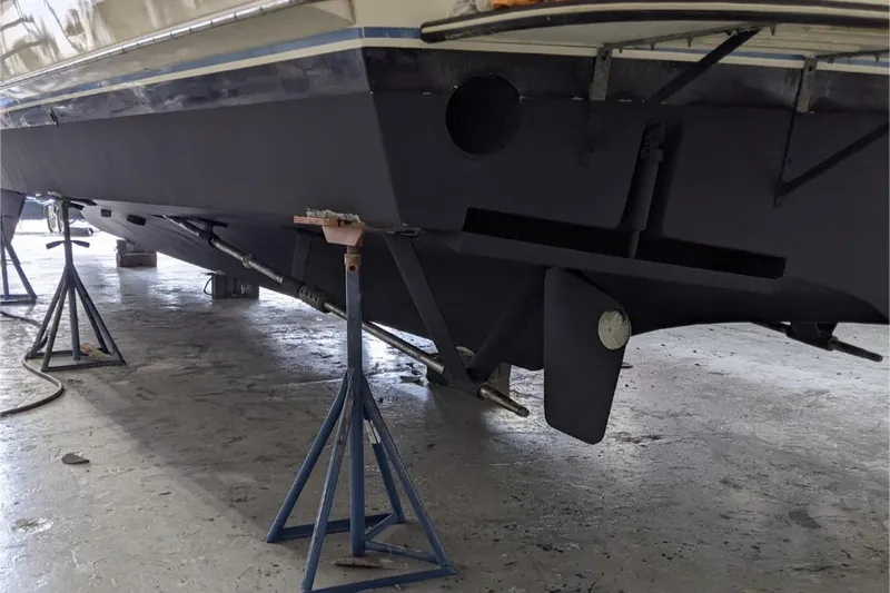 Sky To Sea Yacht Photos Pics 1984 Hatteras 53 Extended Deckhouse Motor Yacht on stands in a workshop.