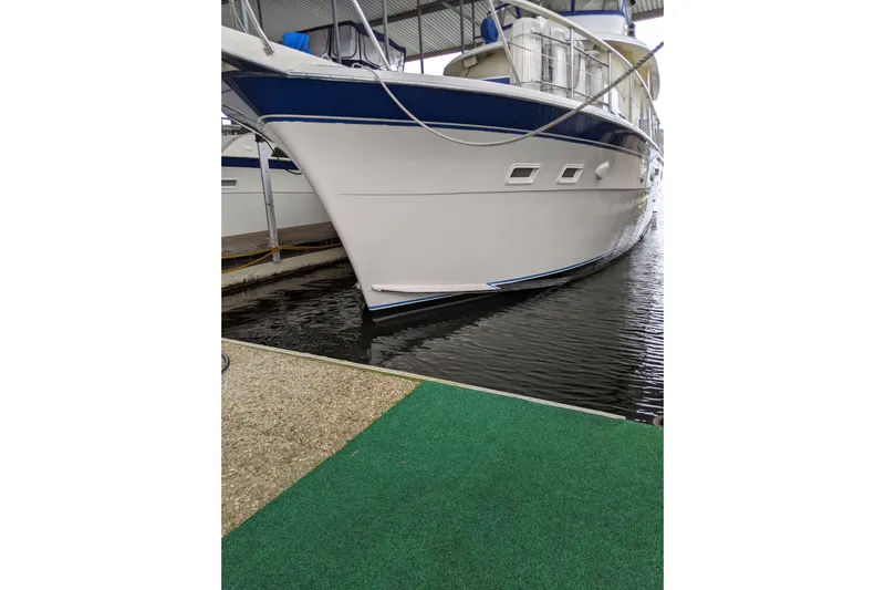 Sky To Sea Yacht Photos Pics 1984 Hatteras 53 Extended Deckhouse Motor Yacht docked in marina.