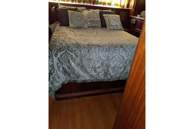 Sky To Sea Yacht Photos Pics Cozy bedroom with patterned bedding on 1984 Hatteras 53 Extended Deckhouse Motor Yacht.