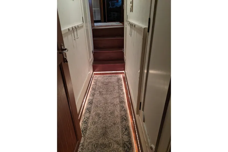 Sky To Sea Yacht Photos Pics Hallway of 1984 Hatteras 53 Extended Deckhouse Motor Yacht with carpet and ambient lighting.