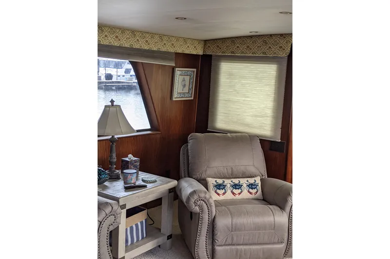 Sky To Sea Yacht Photos Pics Interior of 1984 Hatteras 53 Yacht with cozy seating and nautical decor.
