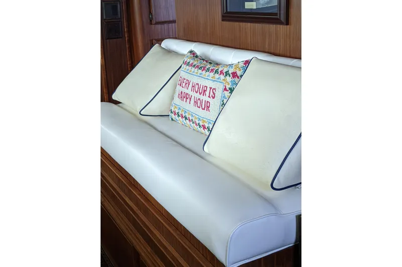 Sky To Sea Yacht Photos Pics Luxurious seating on 1984 Hatteras 53 Motor Yacht with decorative pillow, "Every Hour is Happy Hour."