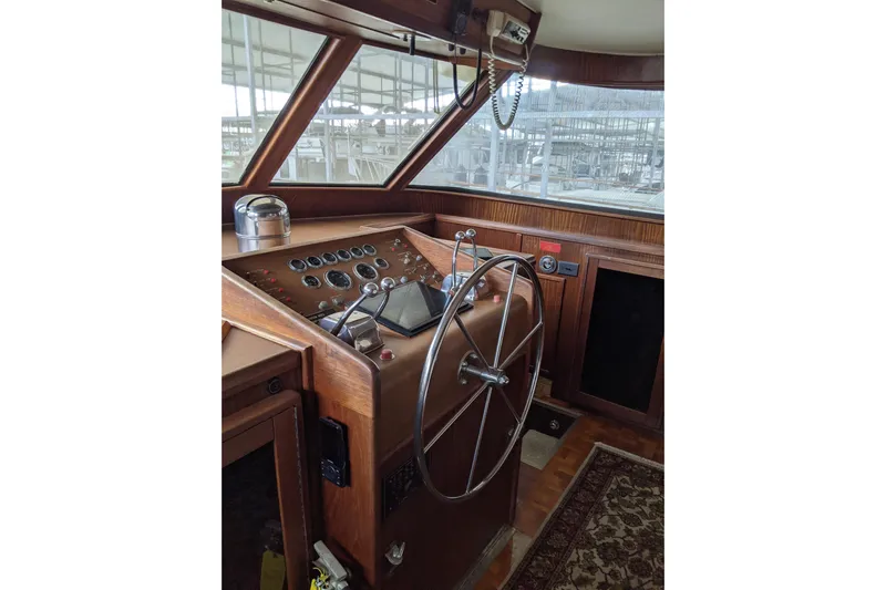 Sky To Sea Yacht Photos Pics 1984 Hatteras 53 Extended Deckhouse Motor Yacht helm with wooden dashboard and steering wheel.