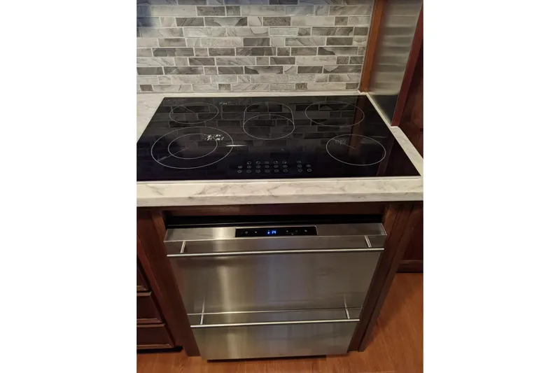 Sky To Sea Yacht Photos Pics Modern kitchen with electric cooktop and stainless steel oven on Hatteras 53 Motor Yacht.