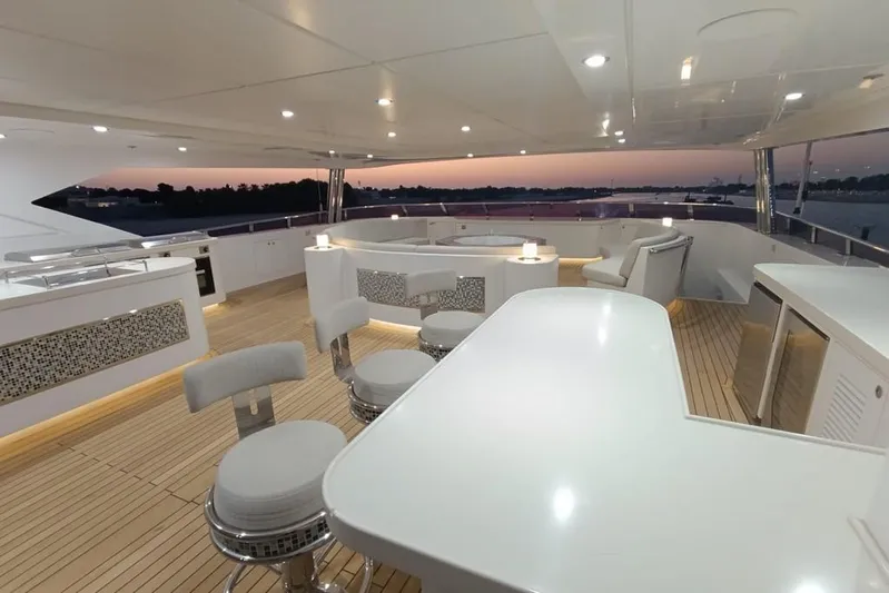 Sehamia Yacht Photos Pics Luxurious 2018 Gulf Craft Majesty 155 yacht deck with elegant seating and sunset view.
