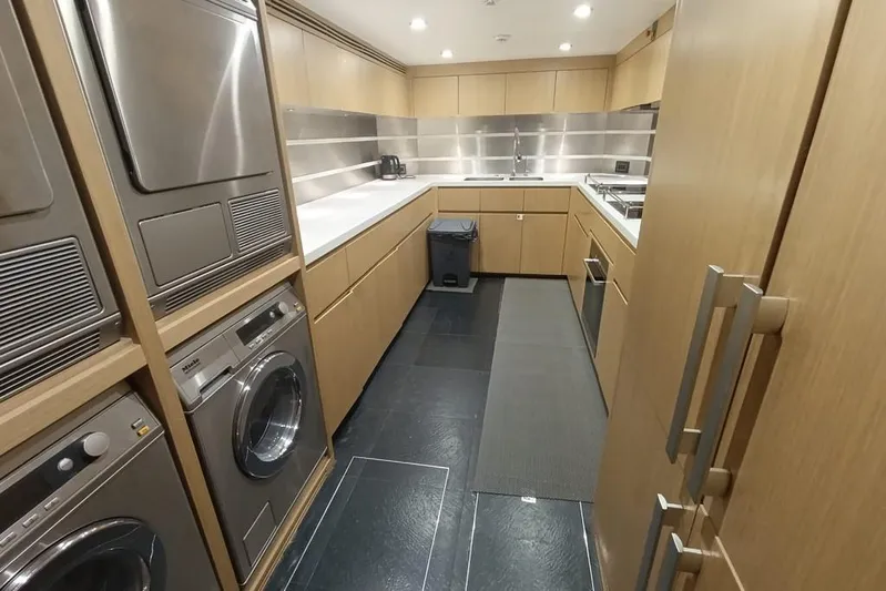 Sehamia Yacht Photos Pics Laundry room on 2018 Gulf Craft Majesty 155 yacht with modern appliances and sleek cabinetry.