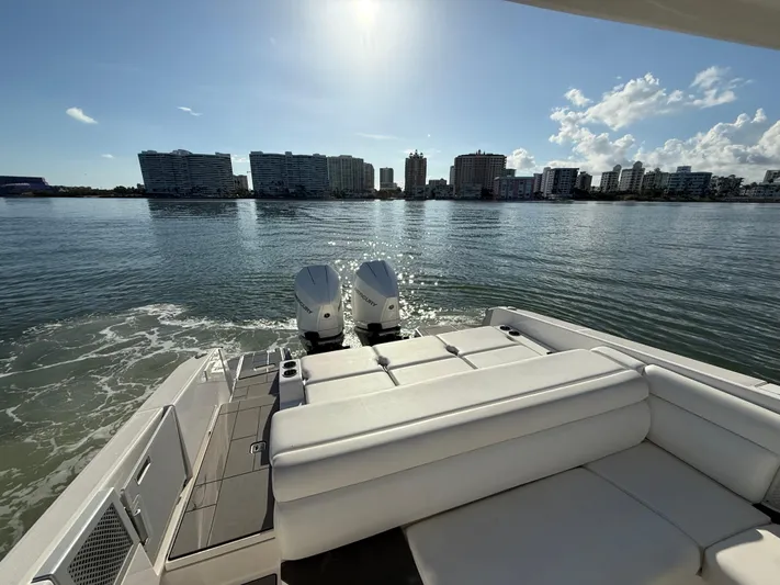  Yacht Photos Pics 2021 Aviara AV32 OB boat with twin engines, city skyline view, sunny day.