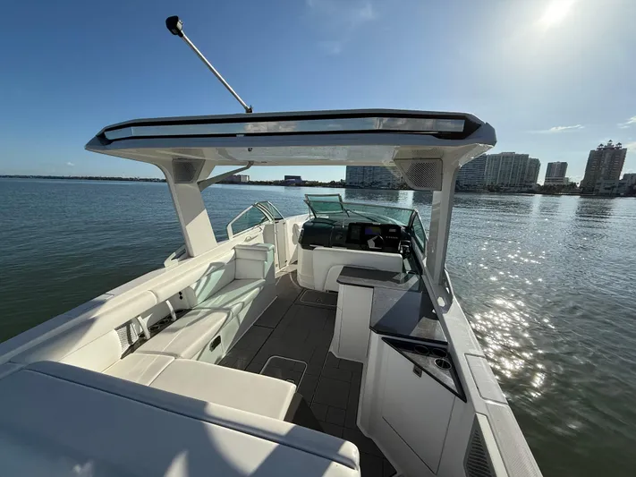  Yacht Photos Pics 2021 Aviara AV32 OB boat interior with seating, helm, and water view.