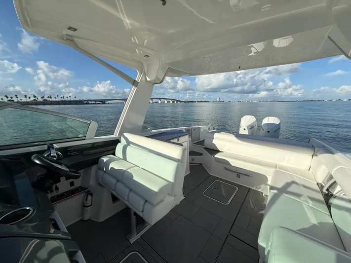  Yacht Photos Pics 2021 Aviara AV32 OB boat interior with seating, steering wheel, and ocean view.