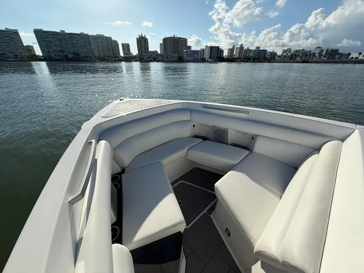  Yacht Photos Pics 2021 Aviara AV32 OB boat with spacious seating, city skyline in background.