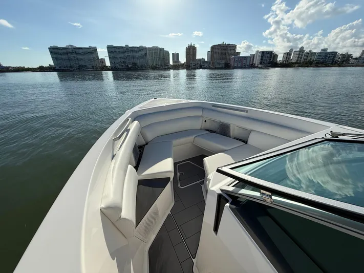  Yacht Photos Pics 2021 Aviara AV32 OB boat with spacious seating, city skyline in background.