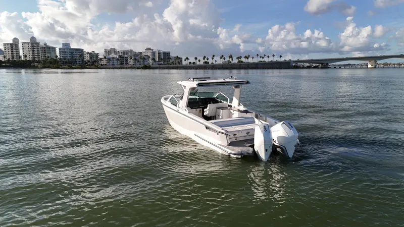  Yacht Photos Pics 2021 Aviara AV32 OB boat on calm water with cityscape background.