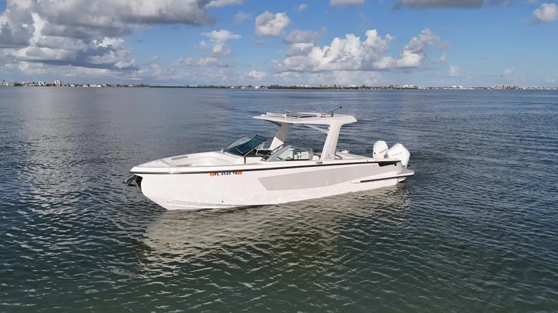  Yacht Photos Pics 2021 Aviara AV32 OB boat on calm water under a partly cloudy sky.