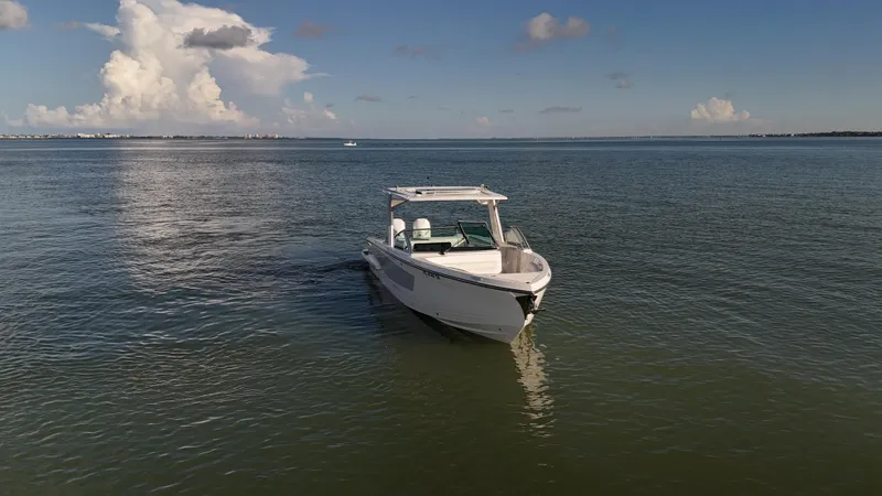  Yacht Photos Pics 2021 Aviara AV32 OB boat on calm water under a clear sky.