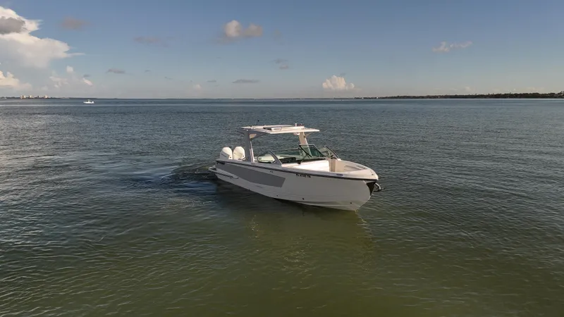  Yacht Photos Pics 2021 Aviara AV32 OB boat cruising on calm waters under a clear sky.