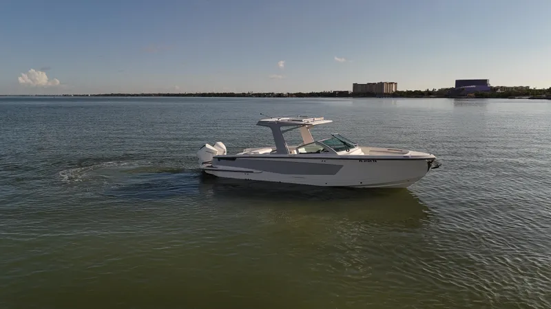  Yacht Photos Pics 2021 Aviara AV32 OB boat cruising on calm waters under a clear sky.