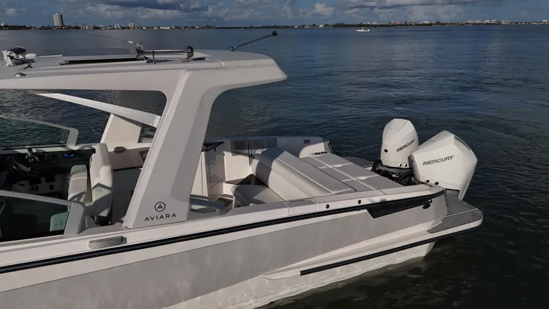  Yacht Photos Pics 2021 Aviara AV32 OB boat with dual Mercury outboard engines on calm water.