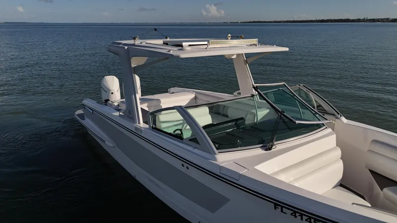  Yacht Photos Pics 2021 Aviara AV32 OB boat on calm water, showcasing sleek design and modern features.