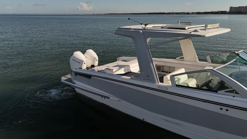  Yacht Photos Pics 2021 Aviara AV32 OB boat on calm water, featuring dual Mercury outboard engines.