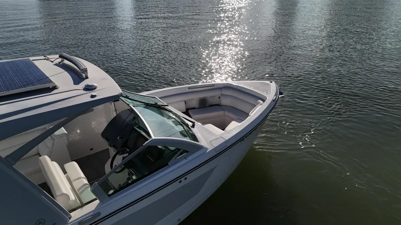  Yacht Photos Pics 2021 Aviara AV32 OB boat on calm water, sunlight reflecting on surface.
