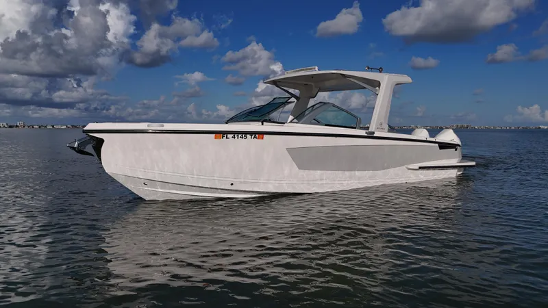  Yacht Photos Pics 2021 Aviara AV32 OB boat on calm water under a partly cloudy sky.