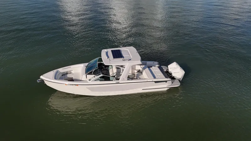  Yacht Photos Pics 2021 Aviara AV32 OB boat on calm water, featuring sleek design and modern outboard motor.