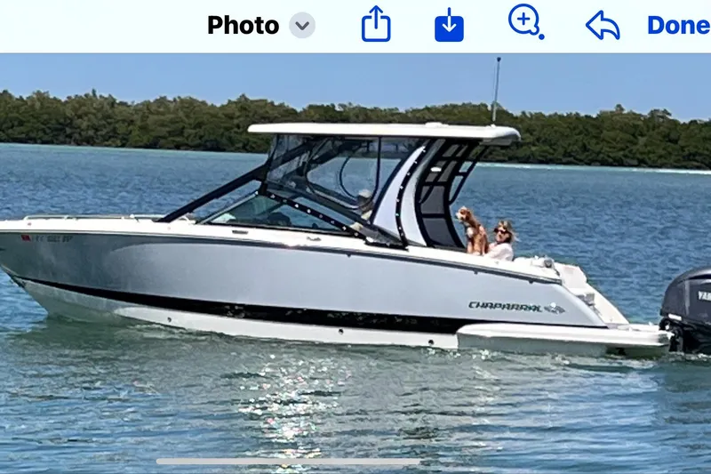  Yacht Photos Pics 2022 Chaparral 280 OSX boat cruising on a sunny day with passengers onboard.