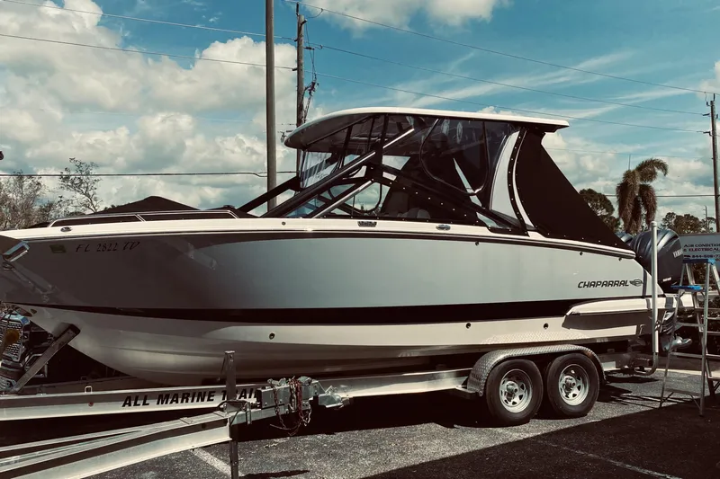  Yacht Photos Pics 2022 Chaparral 280 OSX boat on trailer under blue sky.