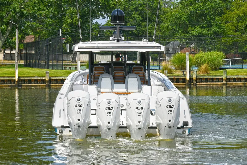 Fourtuna 2 Yacht Photos Pics 2023 Everglades 455 Center Console boat with four powerful 450 V8 engines on a calm waterway.