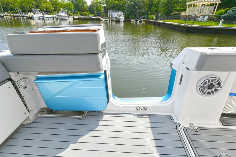 Fourtuna 2 Yacht Photos Pics 2023 Everglades 455 Center Console boat interior with seating and water view.