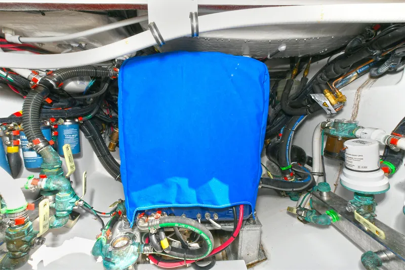 Fourtuna 2 Yacht Photos Pics Engine compartment of 2023 Everglades 455 Center Console with blue cover and wiring.