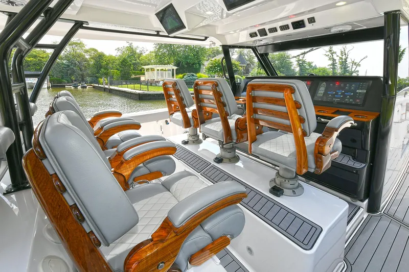 Fourtuna 2 Yacht Photos Pics Luxurious 2023 Everglades 455 Center Console boat interior with plush seating and advanced controls.