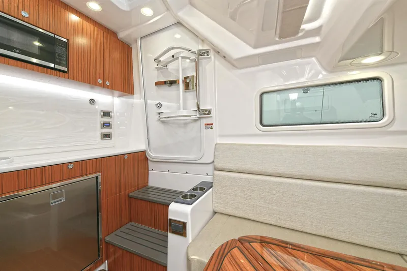 Fourtuna 2 Yacht Photos Pics 2023 Everglades 455 Center Console cabin interior with wood accents and modern amenities.