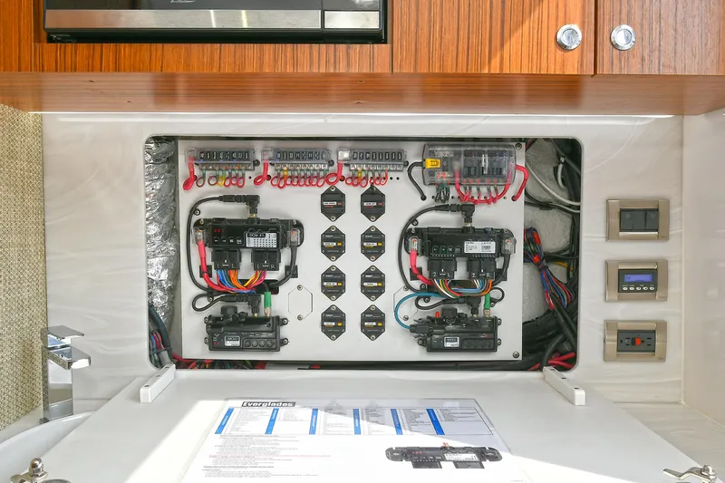 Fourtuna 2 Yacht Photos Pics Electrical panel of 2023 Everglades 455 Center Console boat, showcasing wiring and controls.