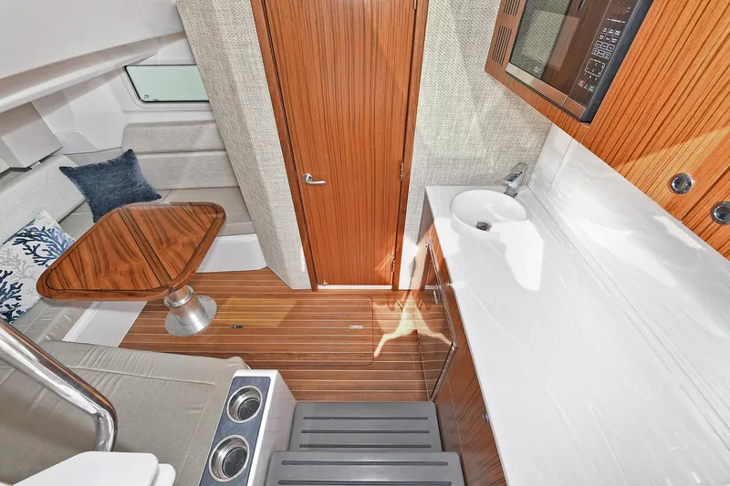 Fourtuna 2 Yacht Photos Pics Interior of 2023 Everglades 455 Center Console with wood accents and modern amenities.