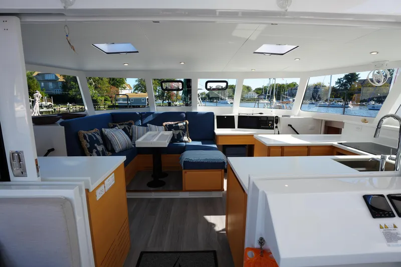 Talise Yacht Photos Pics Luxurious interior of 2024 Balance 442 yacht with modern seating and kitchen area.