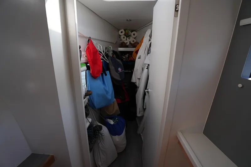 Talise Yacht Photos Pics Narrow storage space on Balance 442 yacht, filled with clothes and supplies, 2024 model.