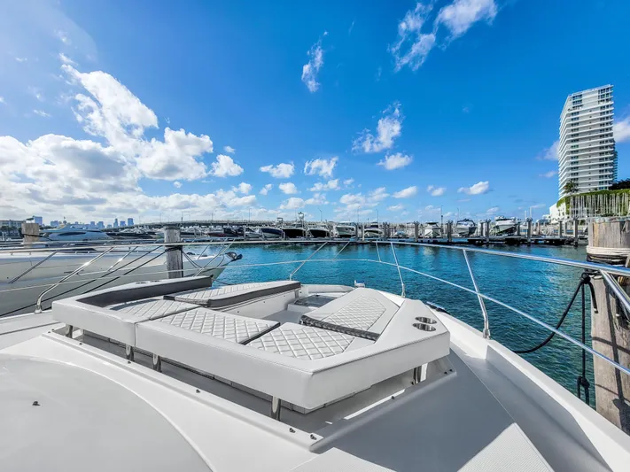  Yacht Photos Pics 2019 Cruisers 50 Cantius yacht docked in a marina with city skyline.