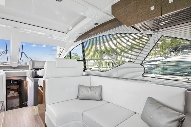  Yacht Photos Pics Interior of 2019 Cruisers 50 Cantius yacht with white leather seating and large windows.