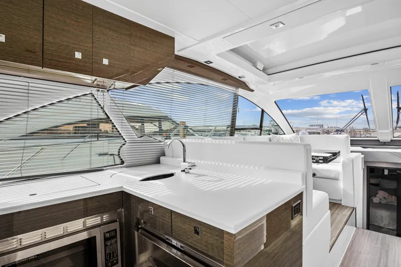  Yacht Photos Pics Interior of 2019 Cruisers 50 Cantius yacht with modern kitchen and panoramic windows.
