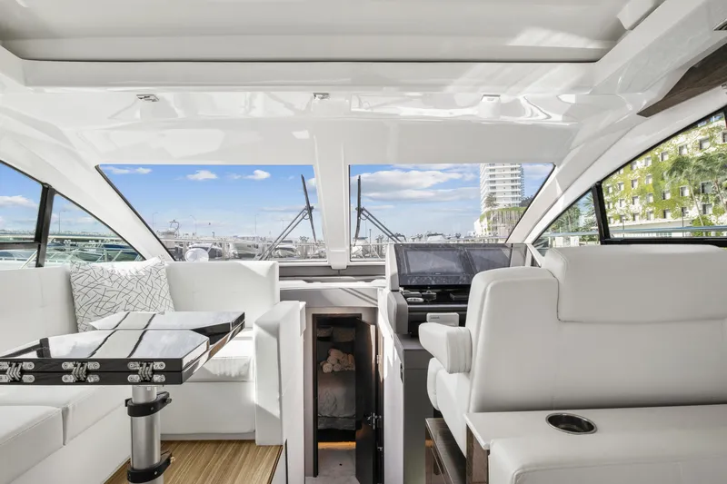  Yacht Photos Pics Interior of 2019 Cruisers 50 Cantius yacht with white seating and modern helm.