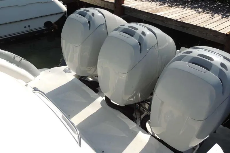  Yacht Photos Pics Triple outboard motors on a 2001 Formula 400 Super Sport boat docked.