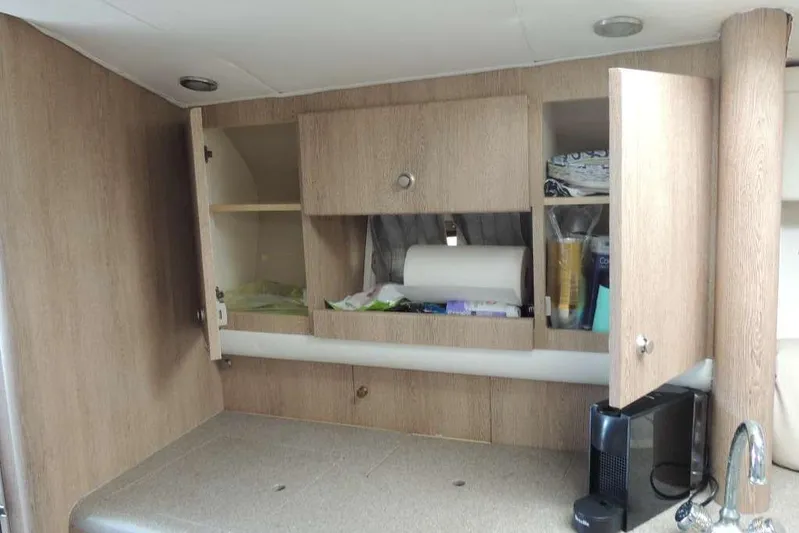  Yacht Photos Pics Interior of 2001 Formula 400 Super Sport with open wooden cabinets and countertop.