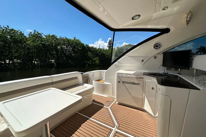  Yacht Photos Pics Luxurious 2012 Sea Ray 470 Sundancer yacht interior with seating, table, and kitchenette.