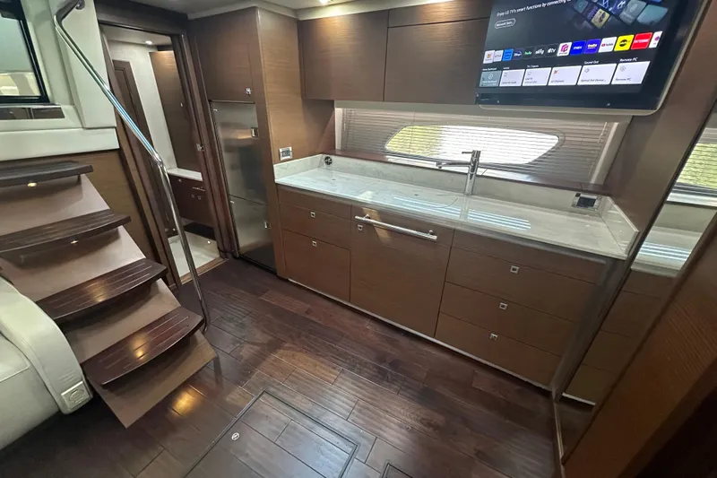  Yacht Photos Pics Luxurious interior of 2012 Sea Ray 470 Sundancer yacht with modern kitchen and wooden flooring.