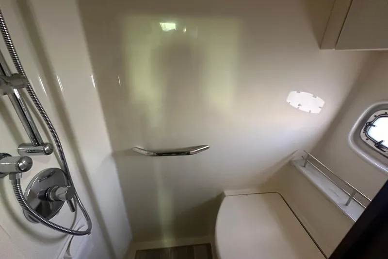  Yacht Photos Pics Shower area in 2012 Sea Ray 470 Sundancer yacht with chrome fixtures and porthole window.